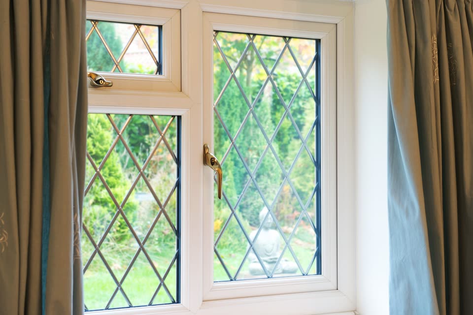 White uPVC casement window with diamond leaded glass, seen from inside