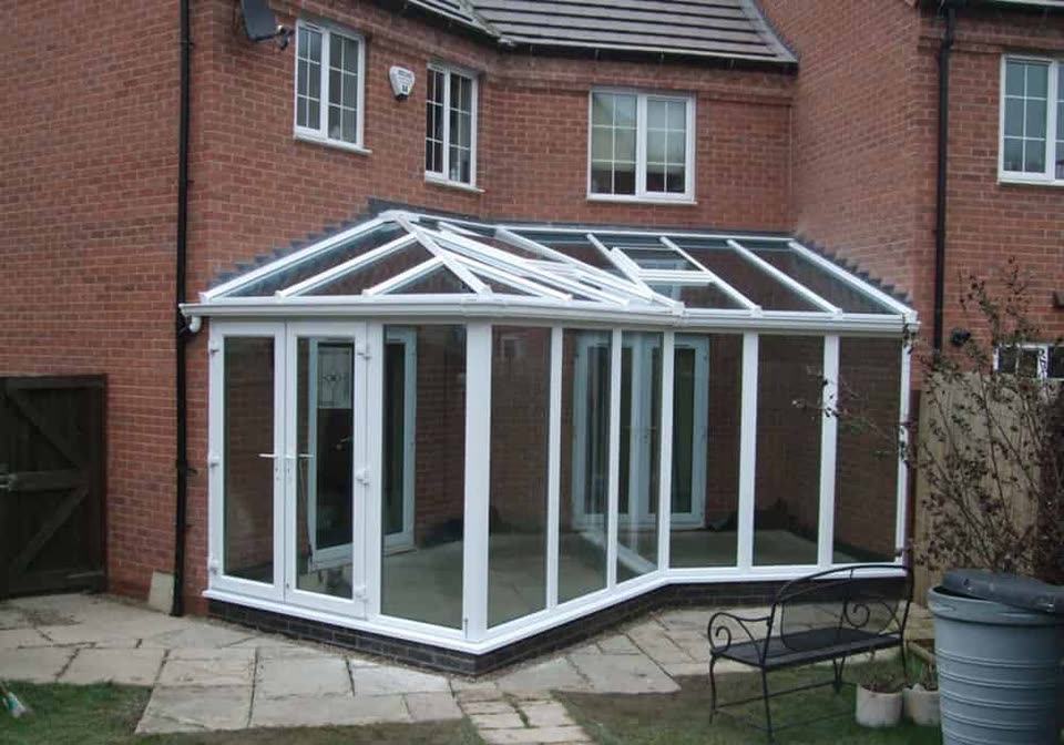 White uPVC conservatory with a glazed roof beside a patio